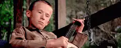 Sleepy boy playing banjo