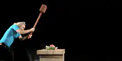 man smashing watermelon with mallet