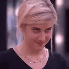 Carrie Underwood smirking and waving