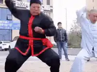 Two men practicing martial arts in a public square