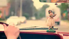 hula dancer bobblehead in car