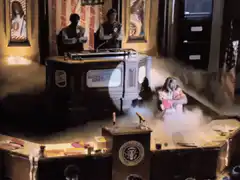 Girl in pink dress appears in smoke