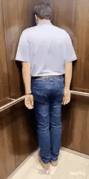 man shaking butt in elevator