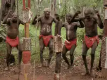 Aboriginal men dancing with spears
