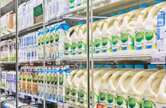 Refrigerated dairy aisle in grocery store