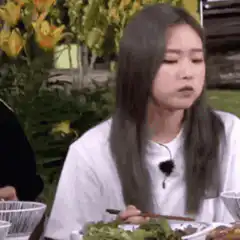 Woman eating and making a face