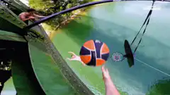 Man jumps off bridge to dunk basketball