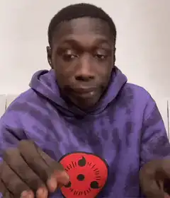 Man in purple hoodie shrugging