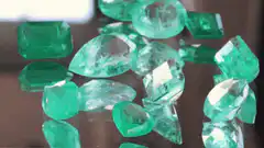 Green gemstones on reflective surface