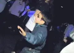 Kid in sunglasses dancing at a party