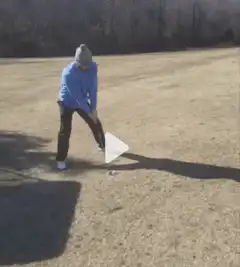 Man hits golf ball with a triangle