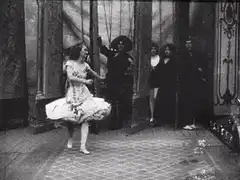 Woman dancing on stage with falling confetti