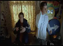 Two guys dancing in a bedroom