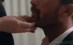 Hand touching man's neck and unbuttoning shirt
