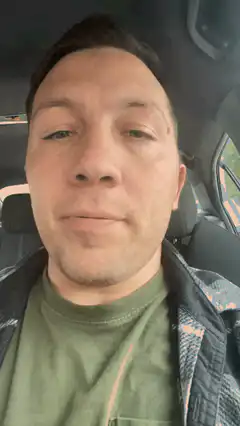 man chewing in car
