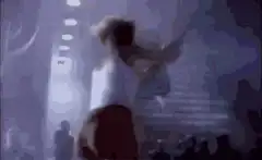 Man on stage with giant face projection