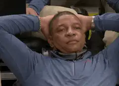 Dr. Dre relaxing with hands behind head