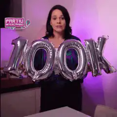 Woman excited holding 100K balloons
