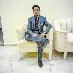 Man in blue suit sitting on chair