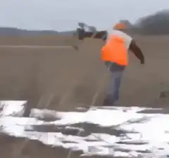 Worker throws shovel into mud