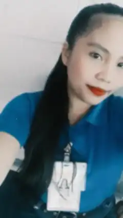 Woman in blue shirt with ID badge