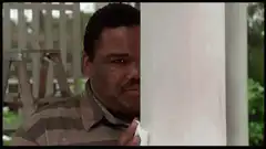 Man peeking from behind a pillar