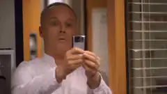Man holding phone with bright flash