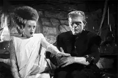Bride of Frankenstein holds hands