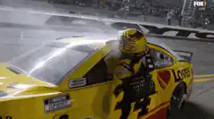 Kyle Busch celebrates on car