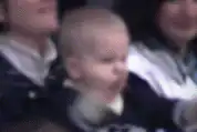Baby screaming with fists clenched