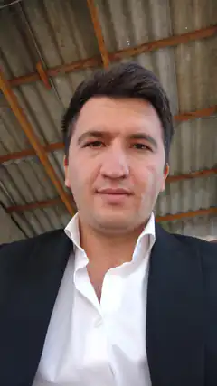 Man in suit under corrugated roof
