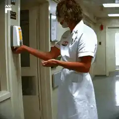 Joker in nurse uniform sanitizing hands