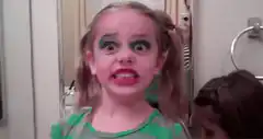 Girl with green eyeshadow making a face