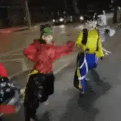 people in funny costumes dancing on street