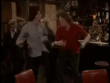 Two men dancing in a pub