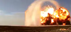Massive desert explosion with fireball and shockwave