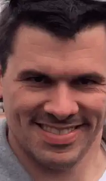 Man Smirking Then Drinking