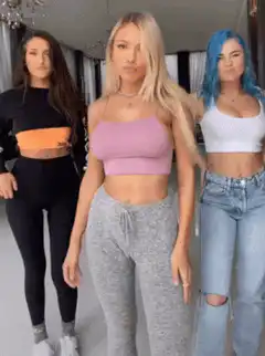 Three women dancing in a hallway