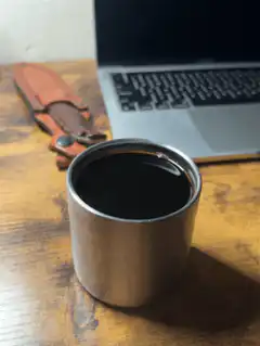 coffee cup and laptop on desk