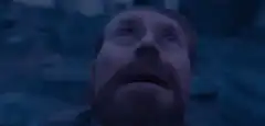 Man looks up then closes eyes