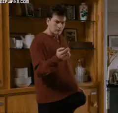 Charlie Sheen looking at phone