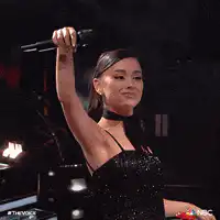 Singer raises hand and waves