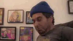 Man in blue beanie triggered
