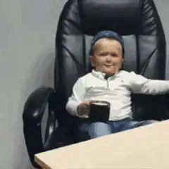 Baby drinking coffee in office chair