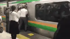 Man pushed into crowded train