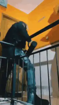 Person in black suit dancing on stairs