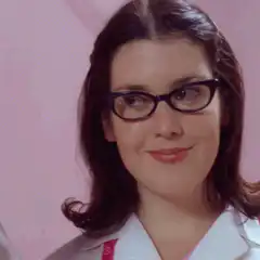 Woman in glasses smirking