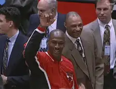 Michael Jordan waving from the bench