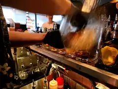 Bartender pouring drinks behind bar