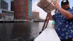 Man throws box off boat
